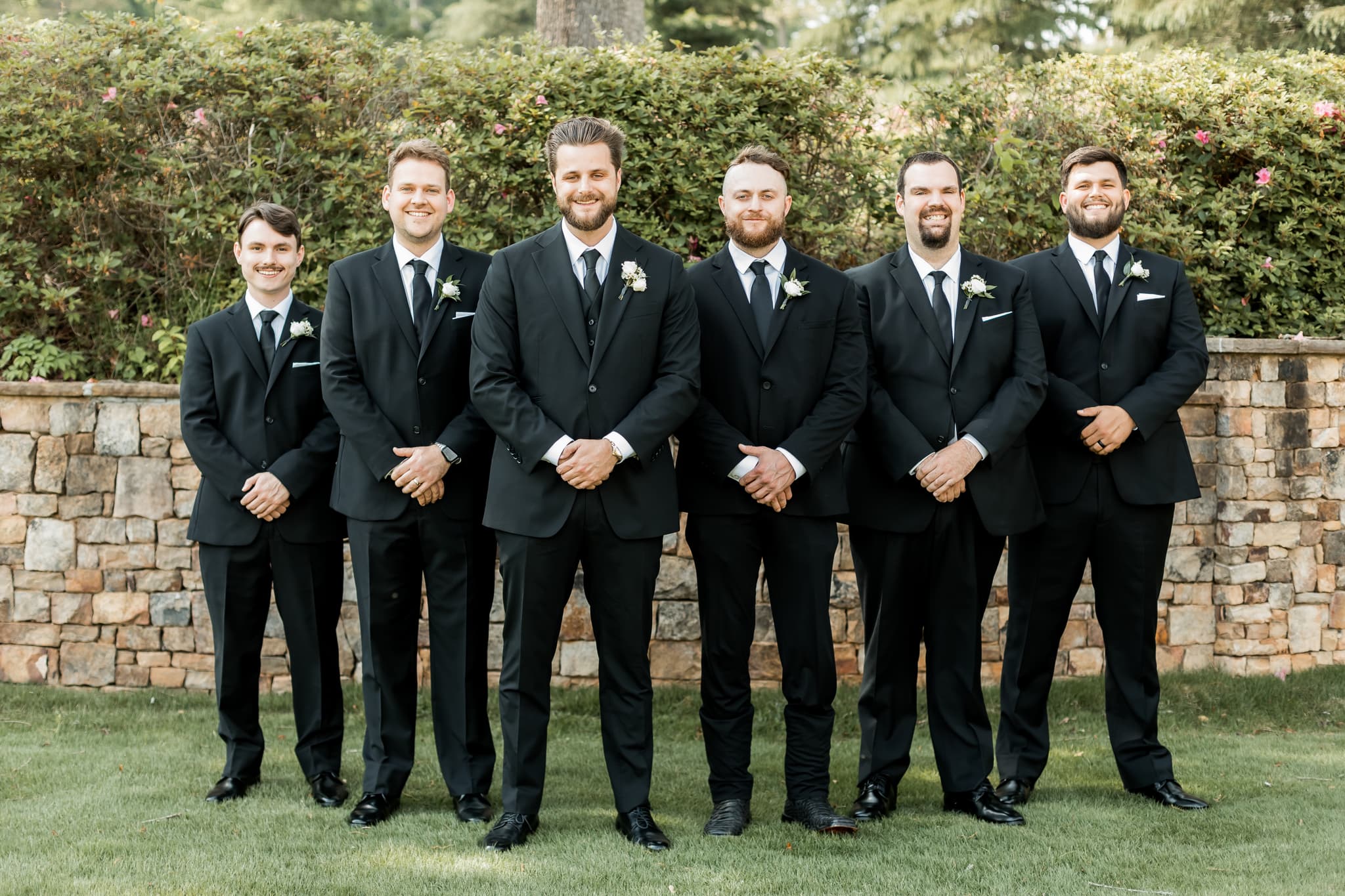 Groomsmen in coordinated black suits