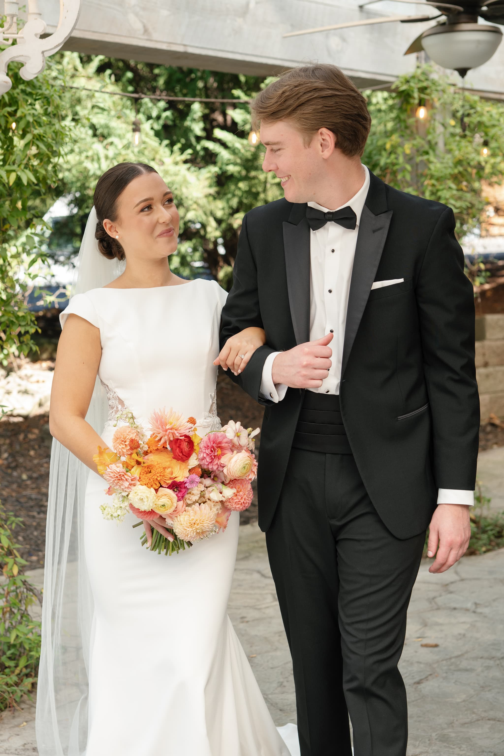Newlywed couple with colorful bouquet