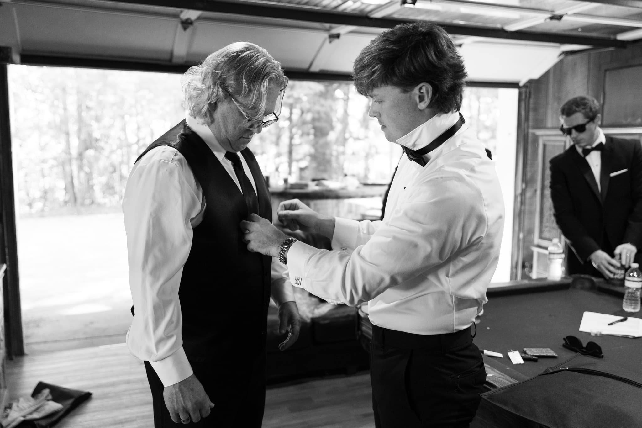 Garrett adjusting a customer's vest for the perfect fit